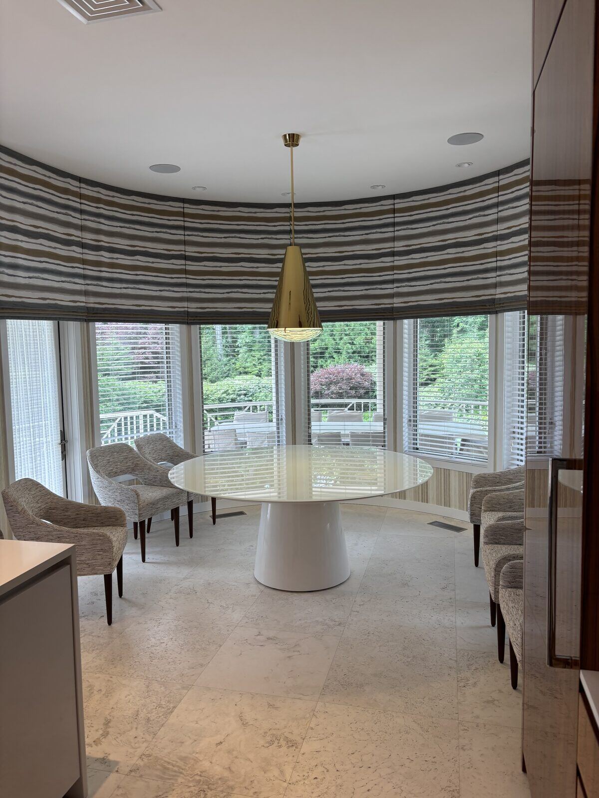 Breakfast nook with a brass cone pendant light installed by Pride Energy