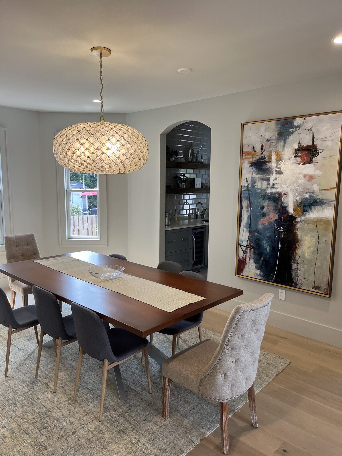 Open-concept dining and living area lighting installed by Pride Energy