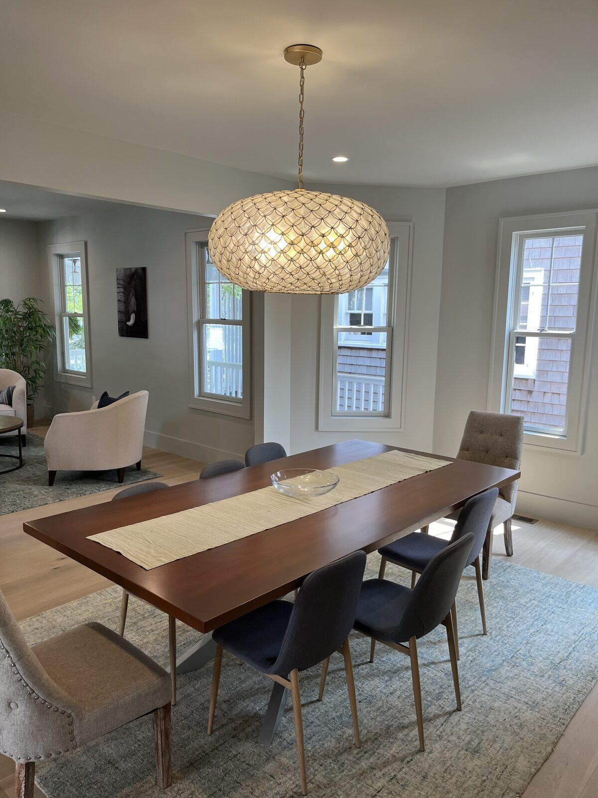 Two-story dining room with a capiz-shell pendant chandelier installed by Pride Energy