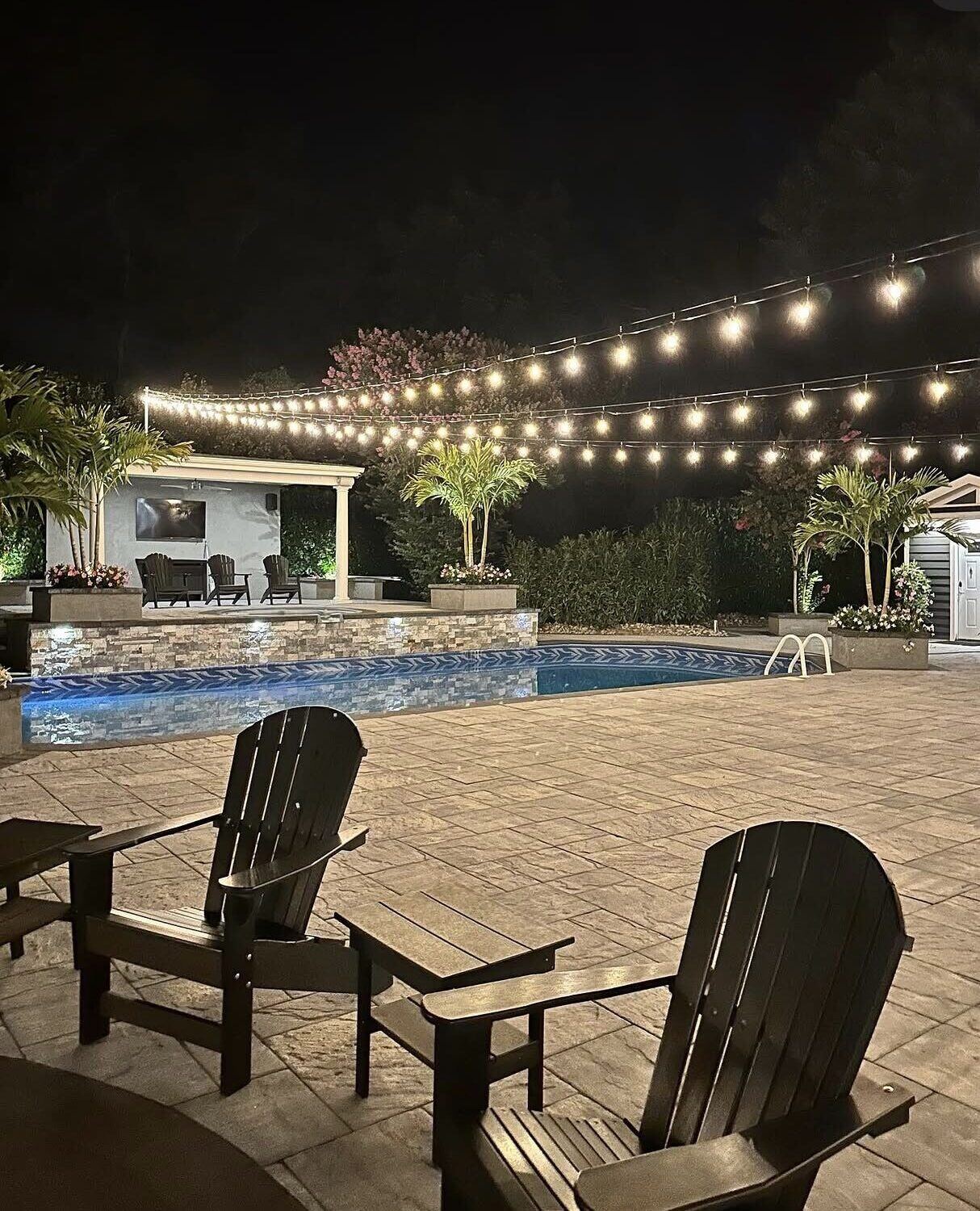 Poolside patio wired for string lights and landscape lighting by Pride Energy