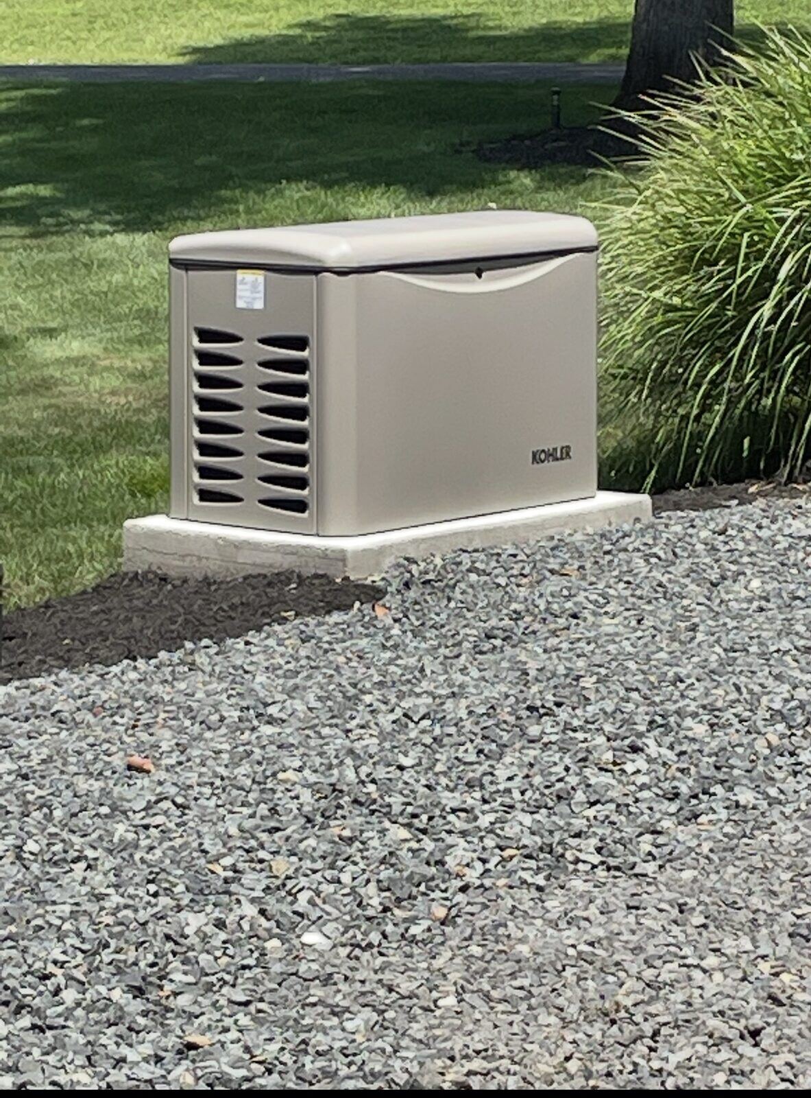 Residential standby generator installed on a concrete pad by Pride Energy in New Jersey